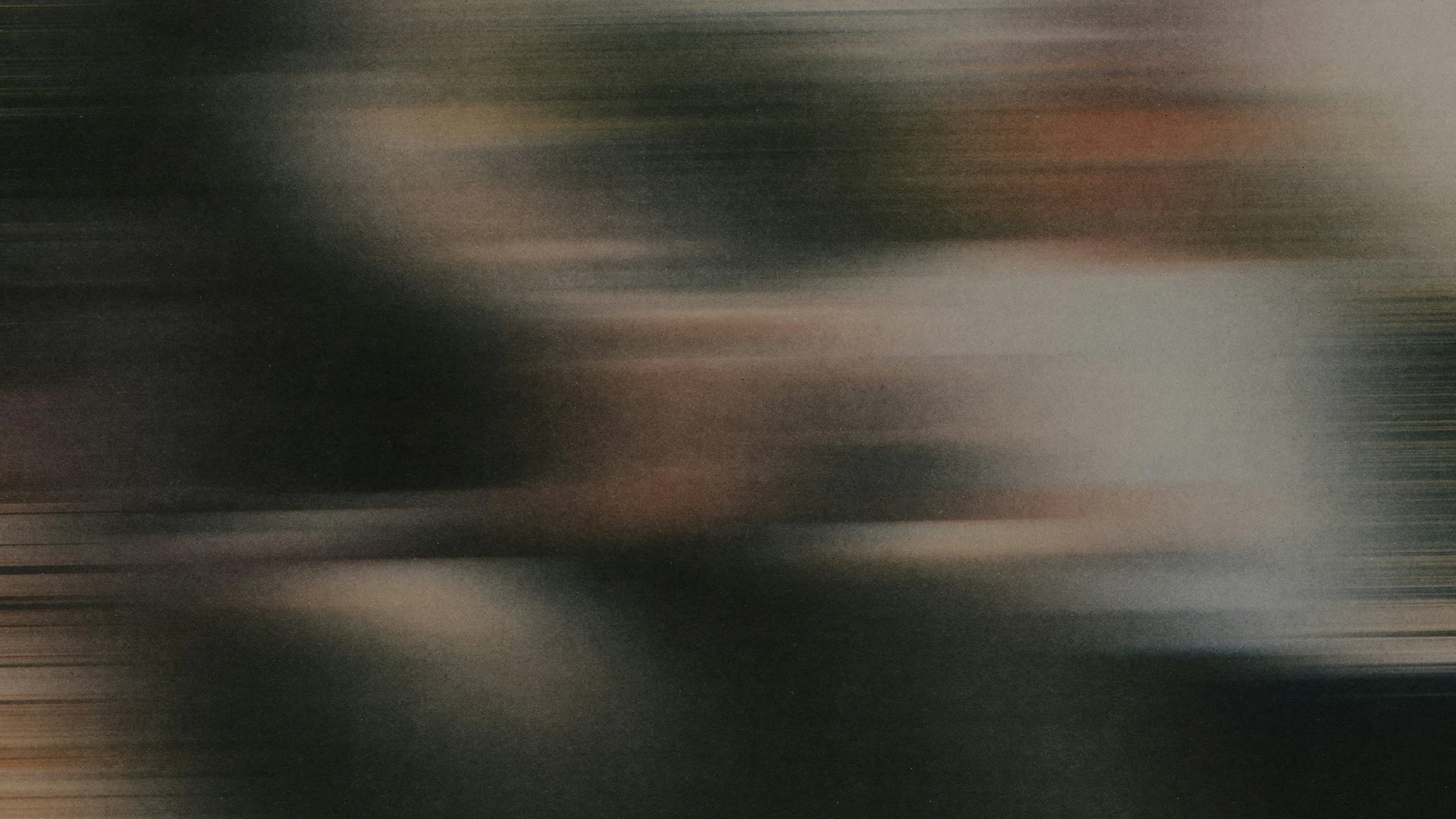 An indistinct figure in motion behind textured glass, in muted green and warm gray tones.